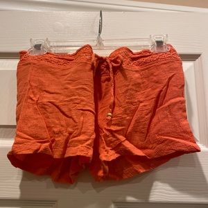 100% cotton, salmon colored shorts with crocheted waist and beaded drawstring.